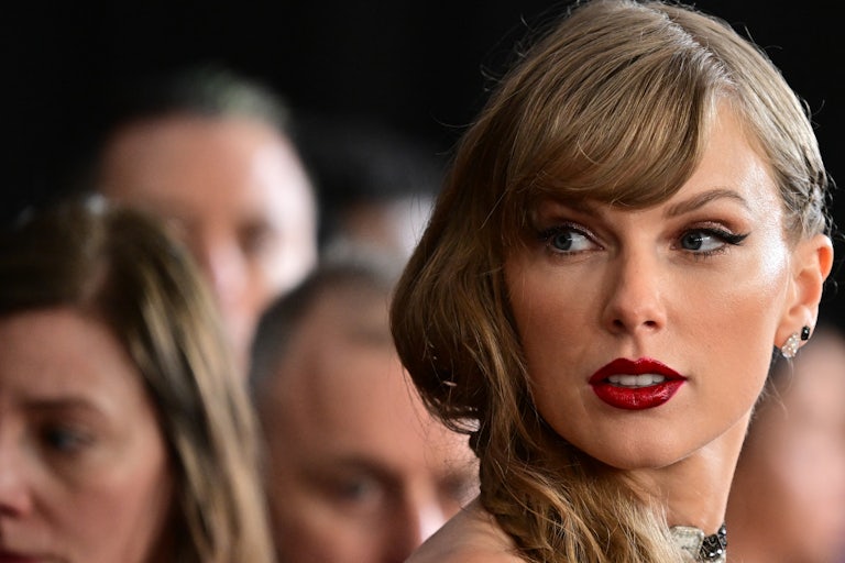 Taylor Swift looks off camera, hair parted to the side.