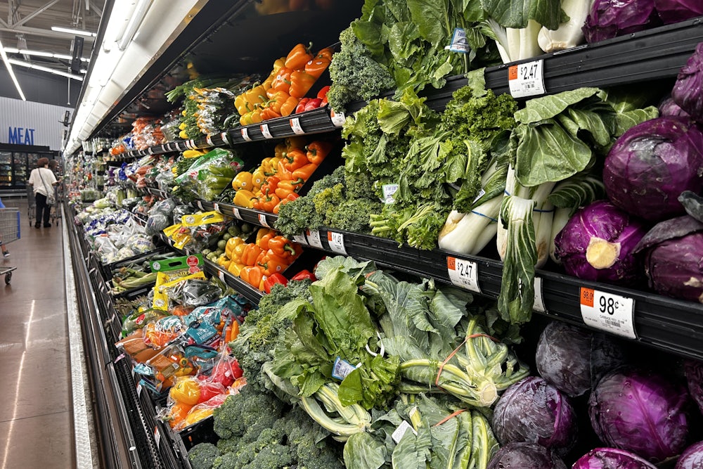 A grocery store aisle filled with produce