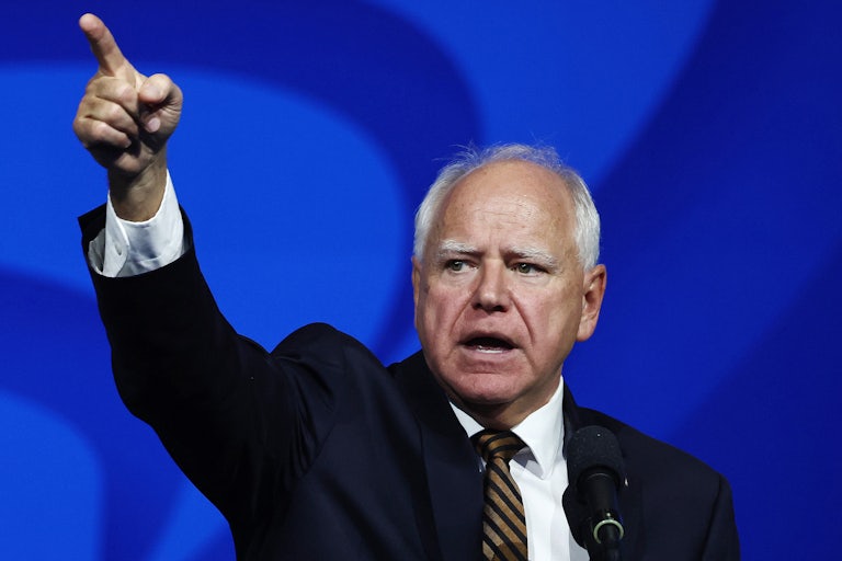 Tim Walz points while speaking at a Kamala Harris rally