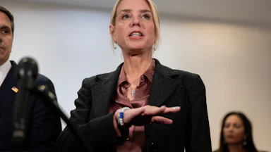 Attorney General Pam Bondi gestures while speaking to reporters