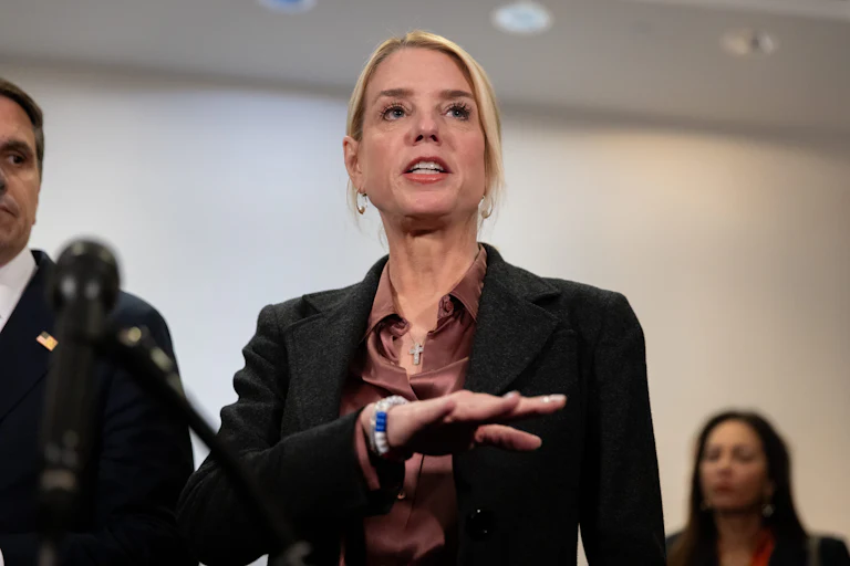 Attorney General Pam Bondi gestures while speaking to reporters