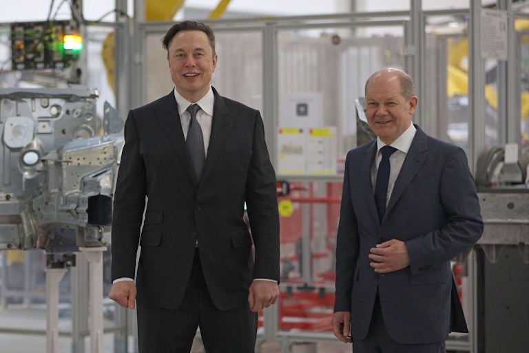 Tesla CEO Elon Musk stands next to German Chancellor Olaf Scholz