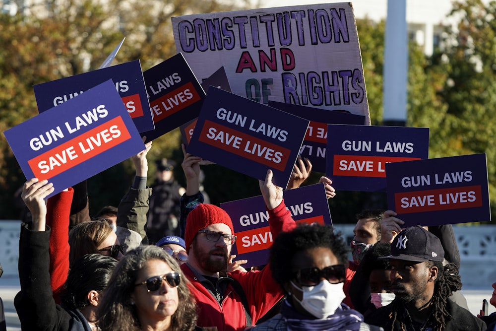 Supporters of gun control hold signs in front of supporters of gun rights during a demonstration by victims of gun violence in front of the Supreme Court.