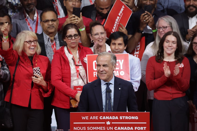 Canadian Prime Minister Mark Carney smiles while standing at a podium during his Election Night victory speech