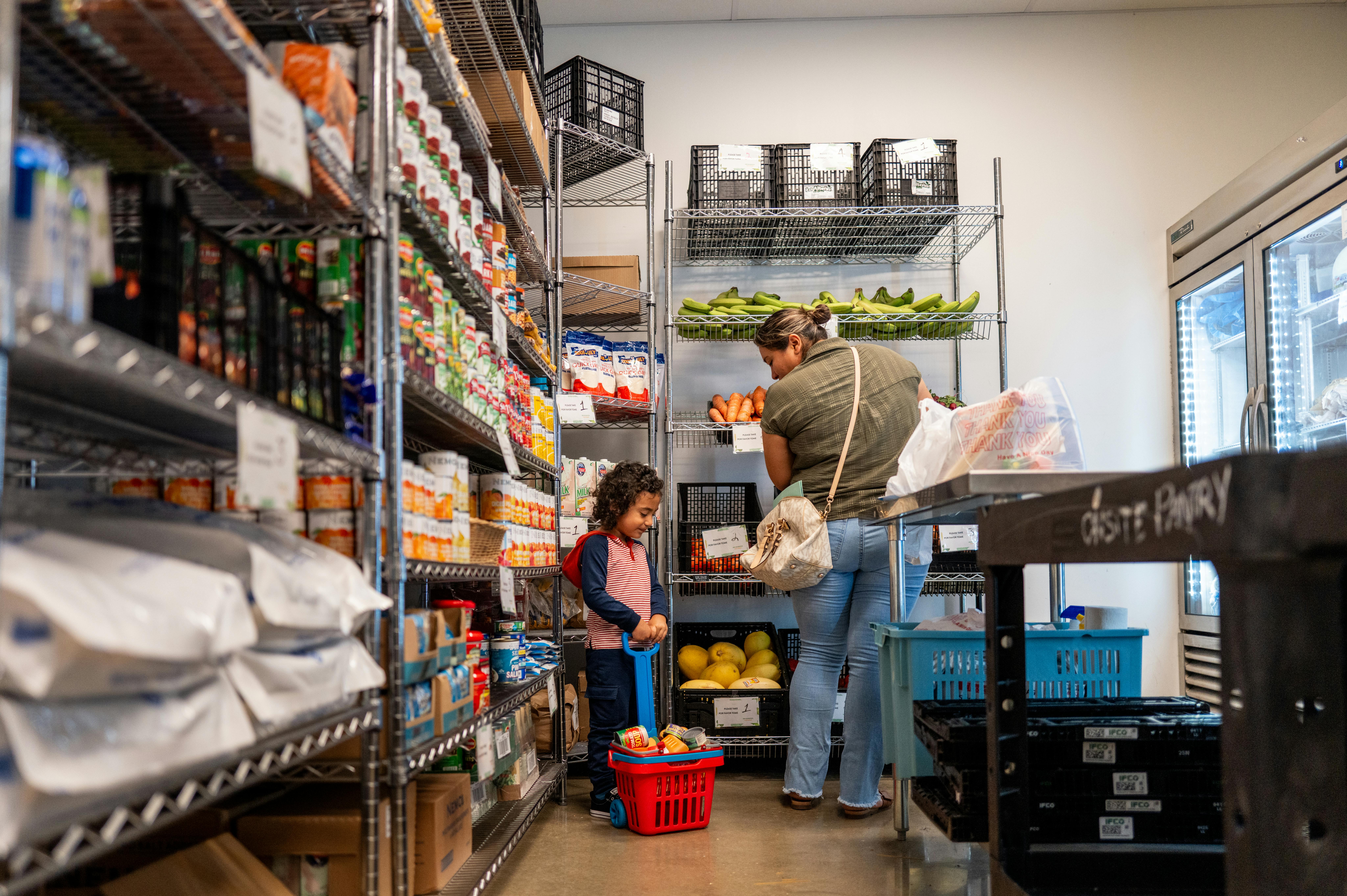 A family gathers food in the community pantry at the Central Texas Food Bank on March 26, 2025 in Austin, Texas. 