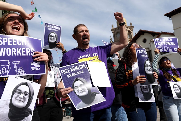 Protesters carry signs reading "Free Rümeysa Our SEIU sister"
