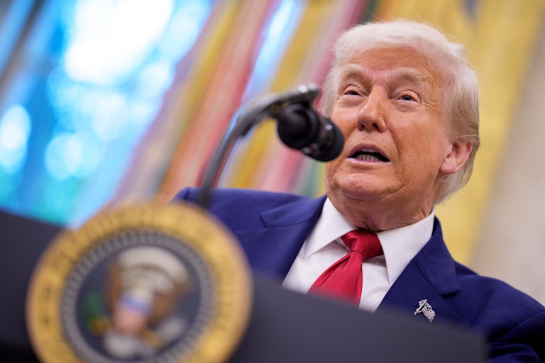 Donald Trump speaks at a podium in the Oval Office