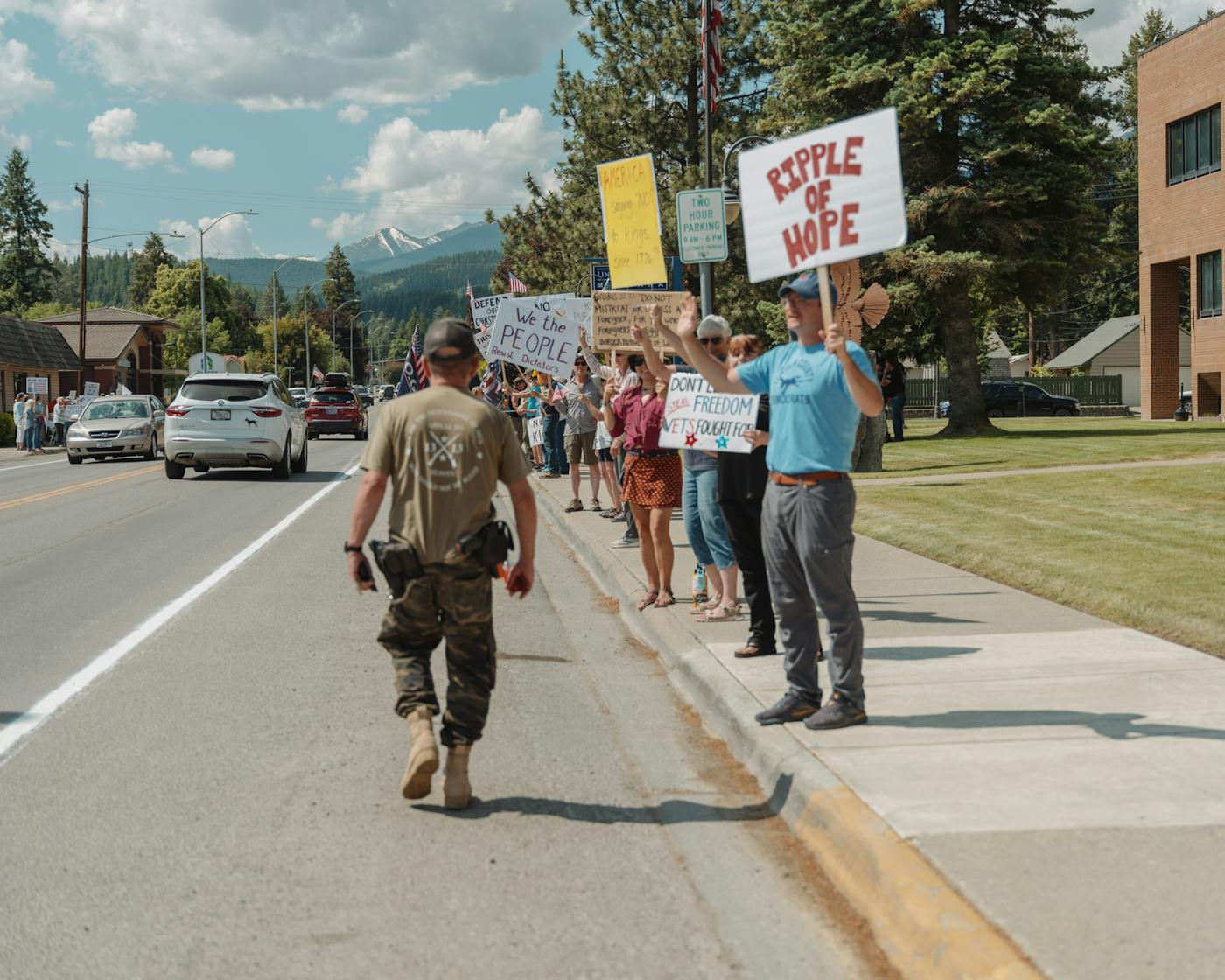 Ricky Gifford, leader of the "Appeal to Heaven" militia walks past a crowd of demonstrators during the No Kings rally in Libby, Montana.