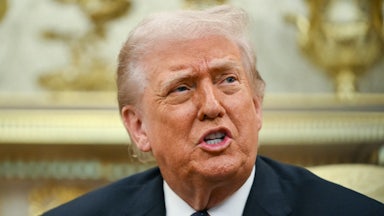 Donald Trump speaks while sitting in the Oval Office