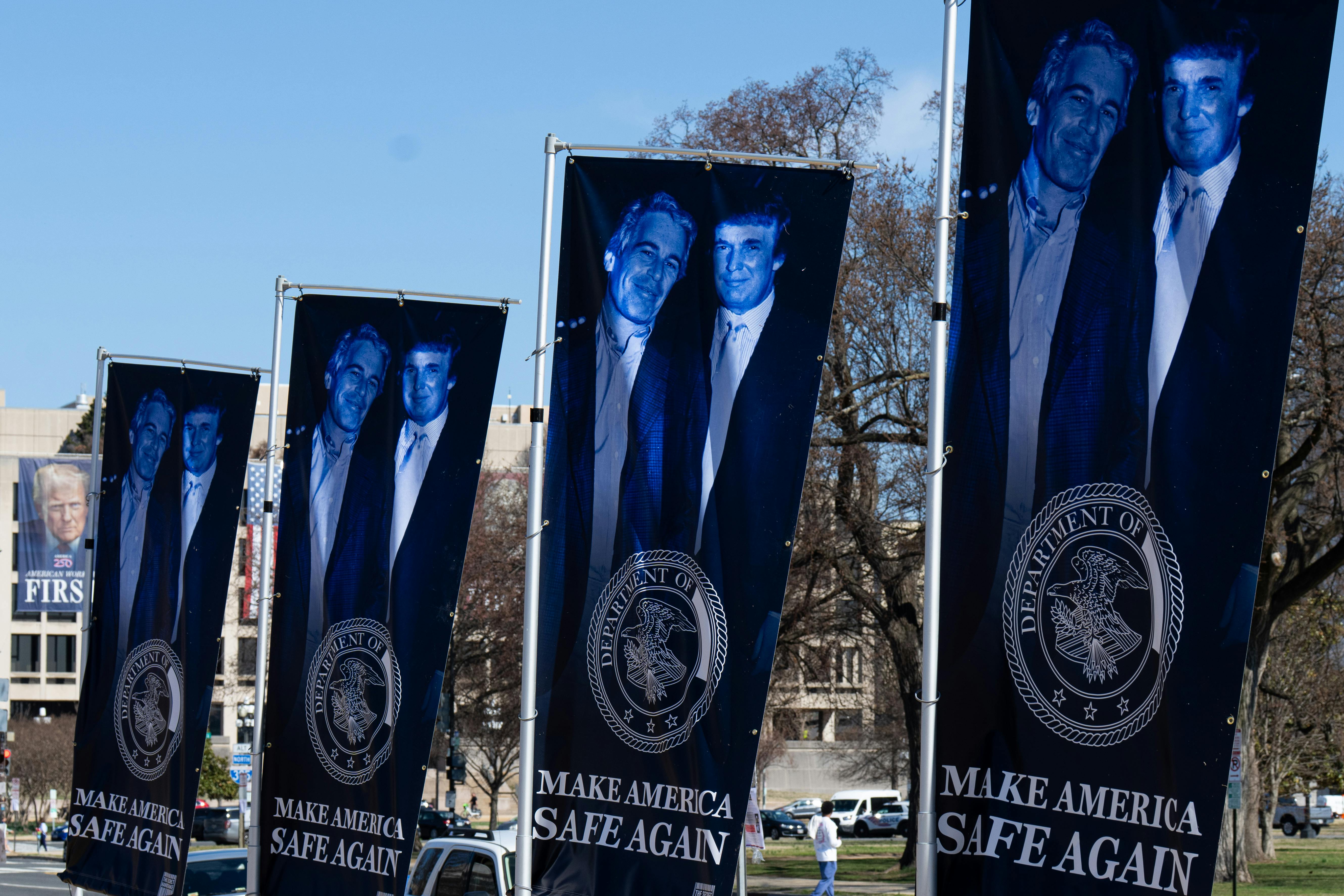 Banners of a photo of Donald Trump and Jeffrey Epstein, emblazoned with the words "Make America Safe Again," stand along the National Mall