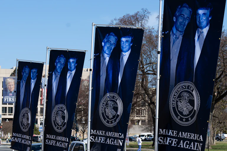 Banners of a photo of Donald Trump and Jeffrey Epstein, emblazoned with the words "Make America Safe Again," stand along the National Mall