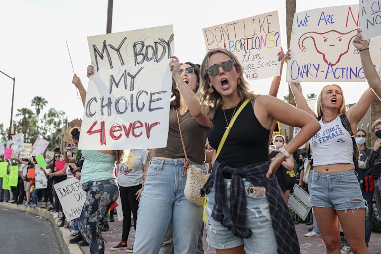 People hold up pro-abortion protest signs
