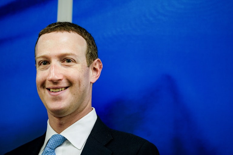Mark Zuckerberg smiles, dorkily.