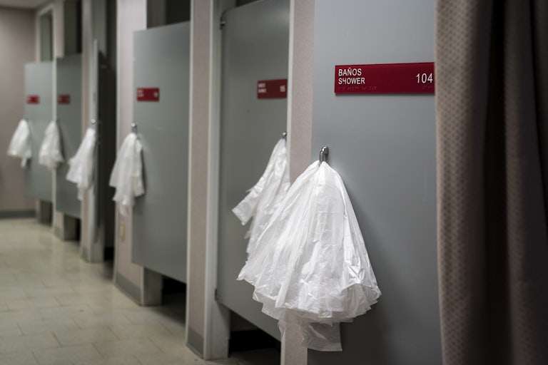 Plastic bags hang on shower doors.