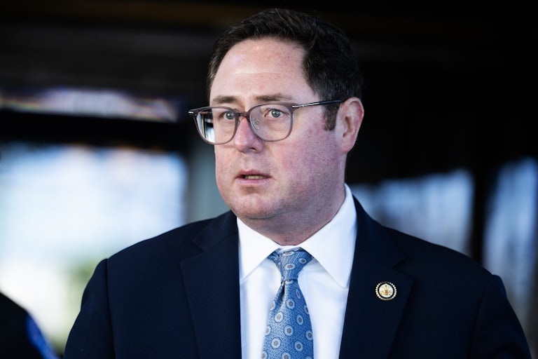 Representative Mike Flood leaves a Republican Party meeting