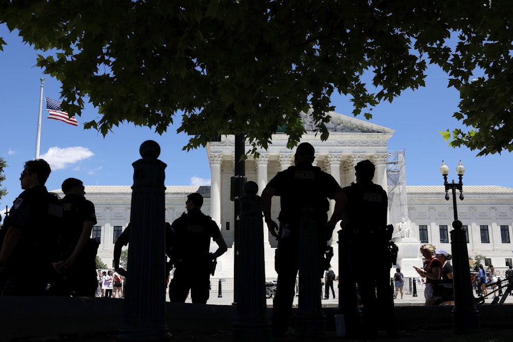 Capitol Police officers observe an abortion rights protest outside of the U.S. Supreme Court Building on June 24.