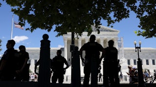 Capitol Police officers observe an abortion rights protest outside of the U.S. Supreme Court Building on June 24.