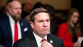 Andrew Bailey adjusts his tie