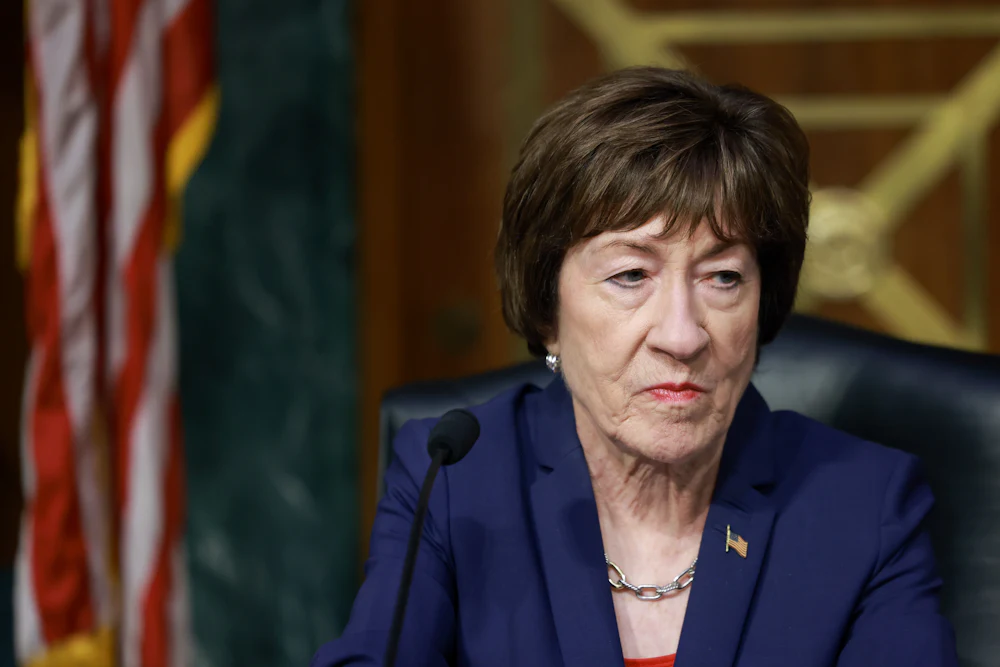 Senator Susan Collins stares listlessly