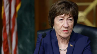 Senator Susan Collins stares listlessly