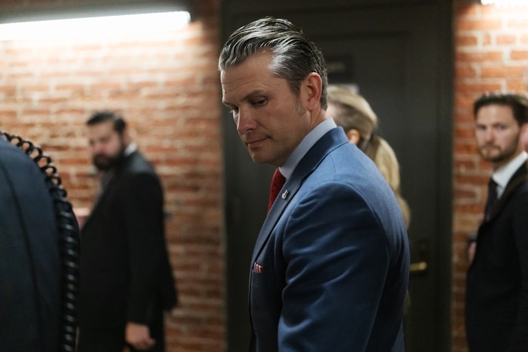 Pete Hegseth looks down while walking in the Capitol