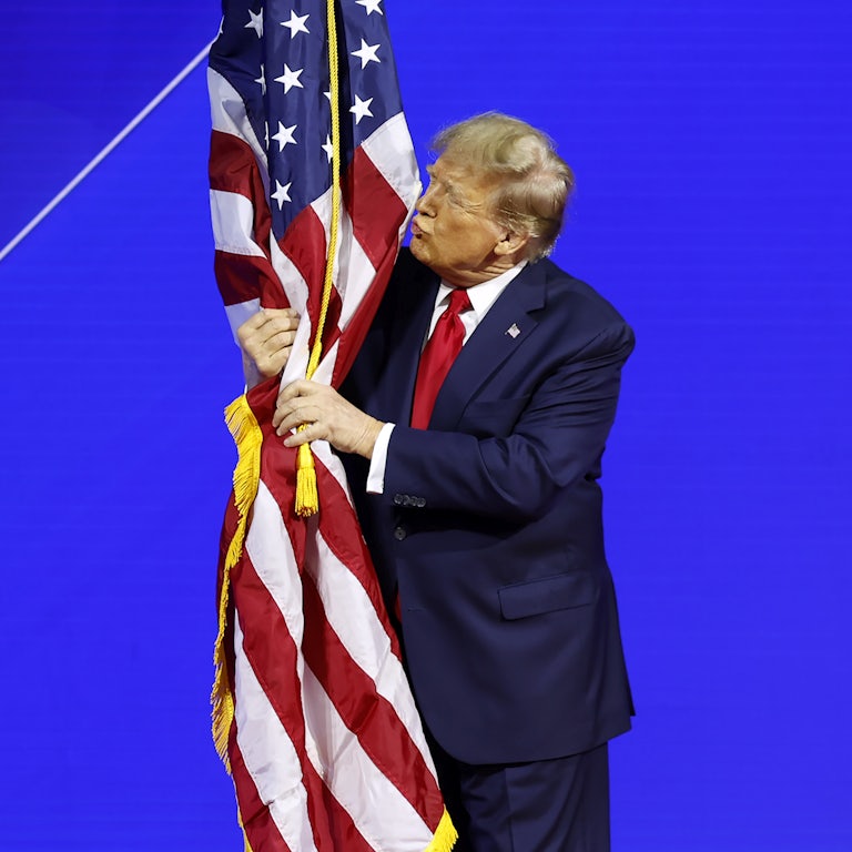 Donald Trump kisses a flag at CPAC. 