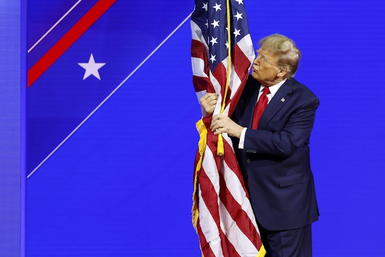 Donald Trump kisses a flag at CPAC.