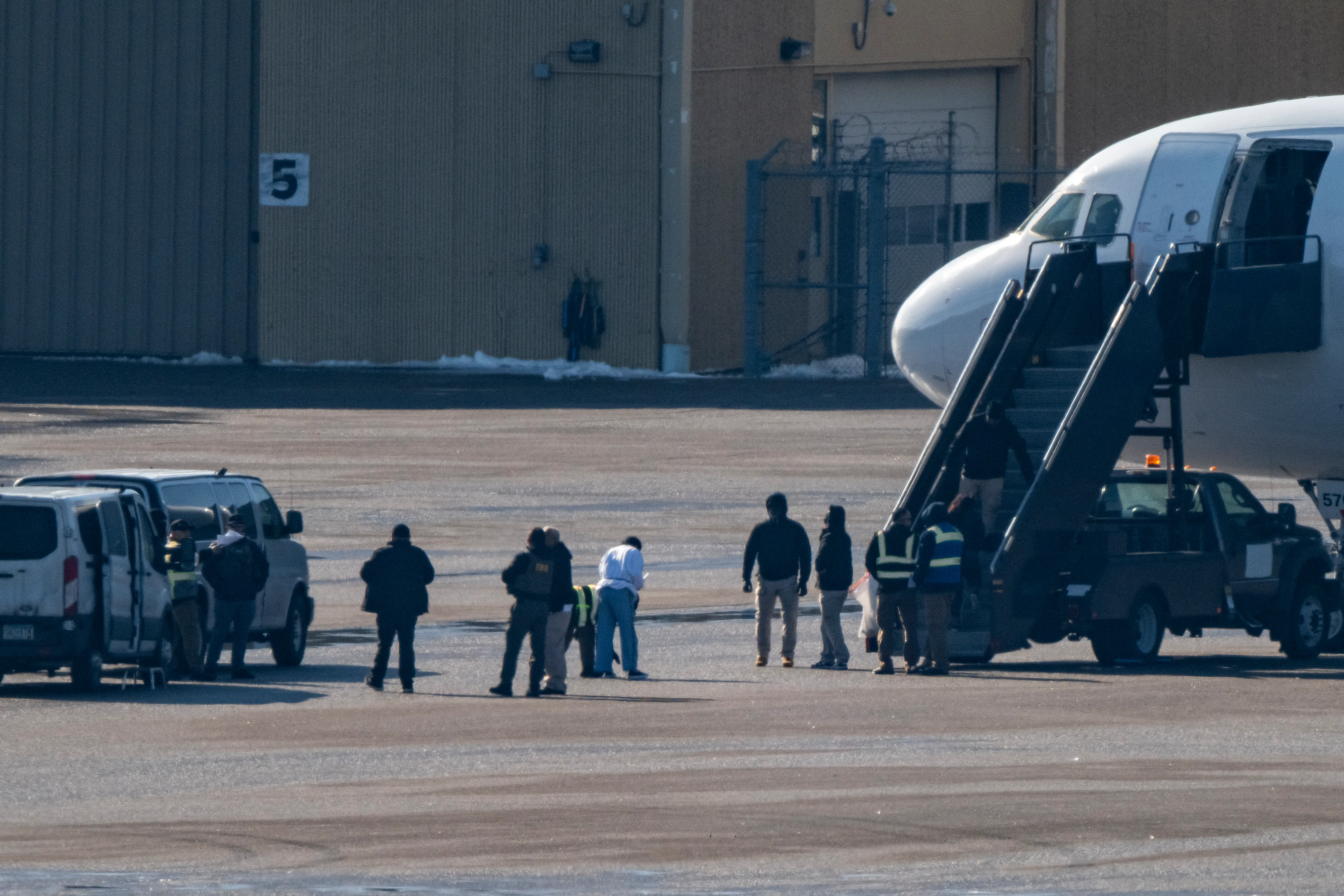 Immigrants board a plane