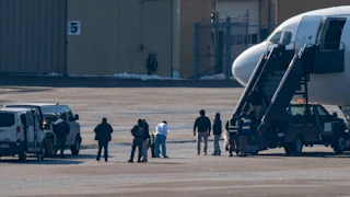 Immigrants board a plane