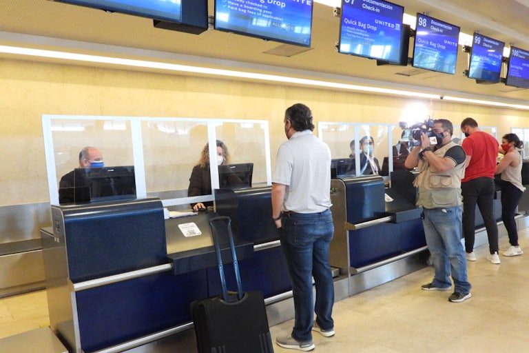 Senator Ted Cruz checks in for a flight at Cancun International Airport. Another camera captures the moment.