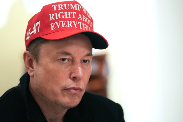 Elon Musk wears a hat that says "Trump Was Right About Everything"