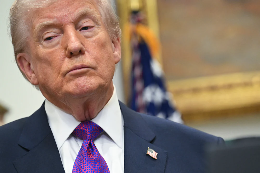 Donald Trump looks down and to the side