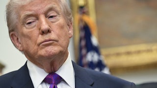 Donald Trump looks down and to the side