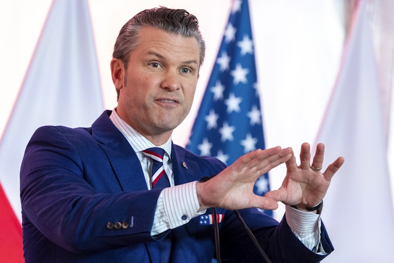 Pete Hegseth gestures while speaking during a press conference in Warsaw, Poland