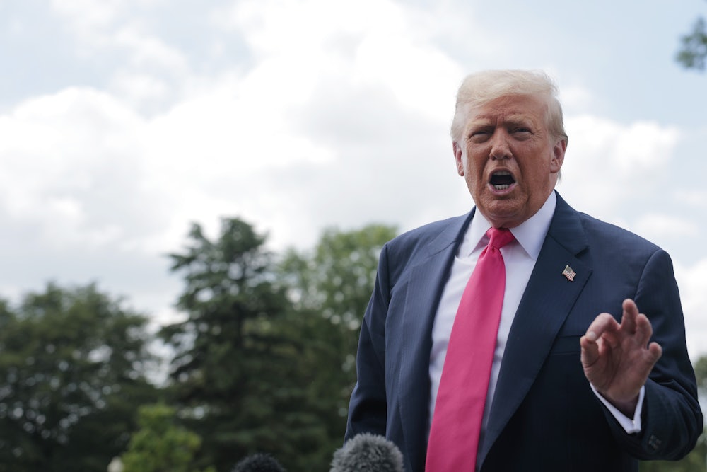 Donald Trump gestures while speaking to reporters outside the White House
