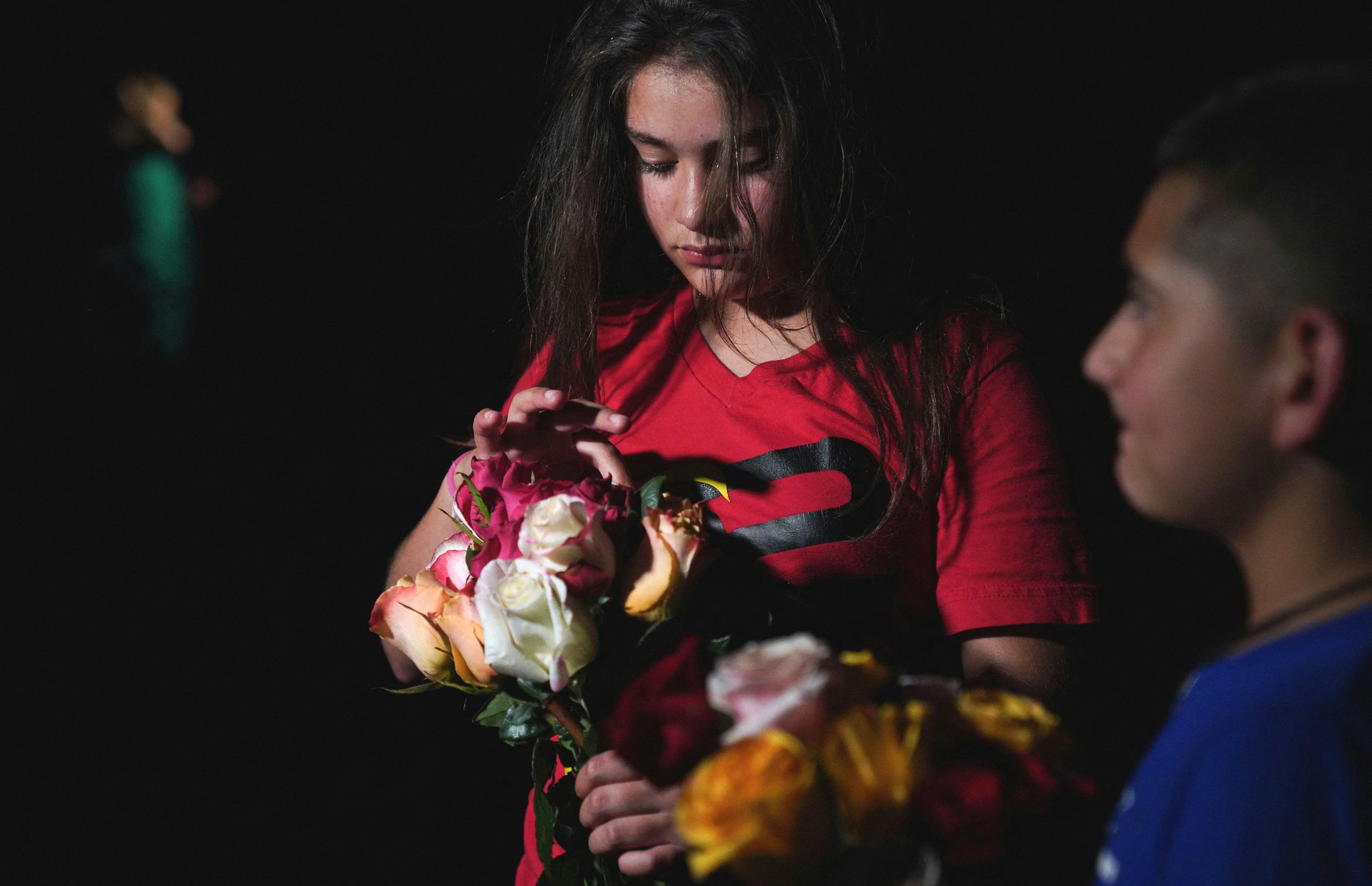 A young girl attends a vigil in Uvalde, Texas