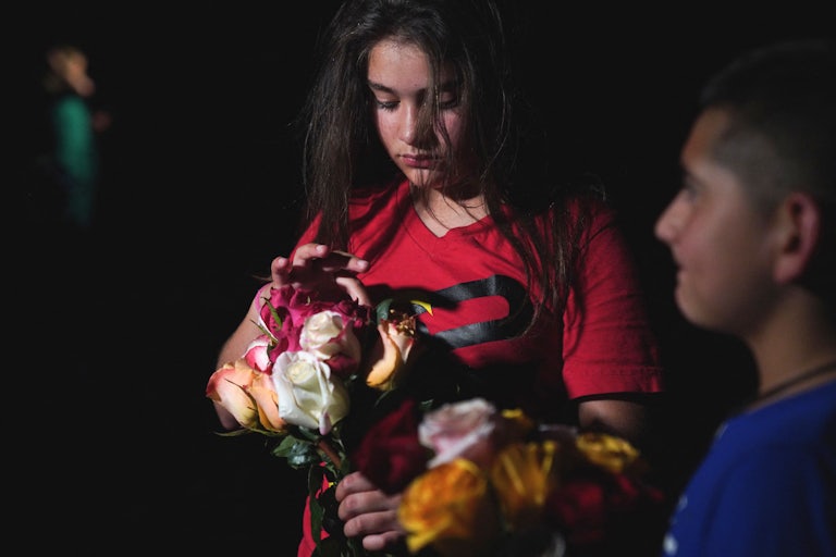 A young girl attends a vigil in Uvalde, Texas