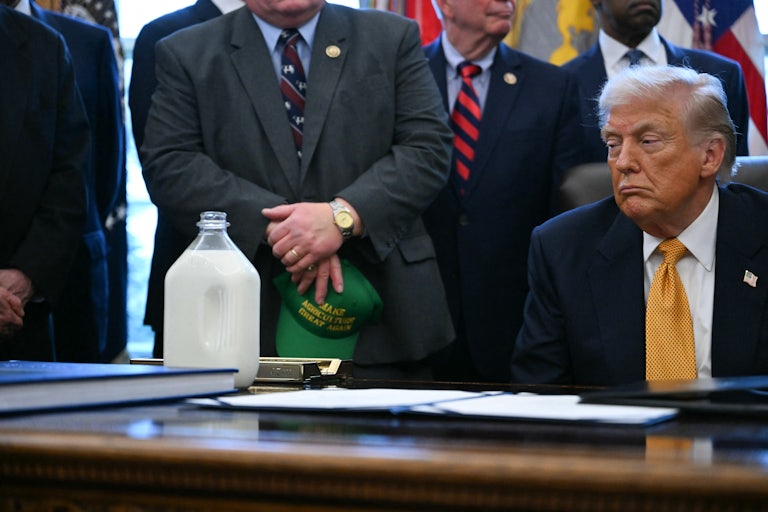 Donald Trump stares at a jug of milk on his desk in the Oval Office of the White House.