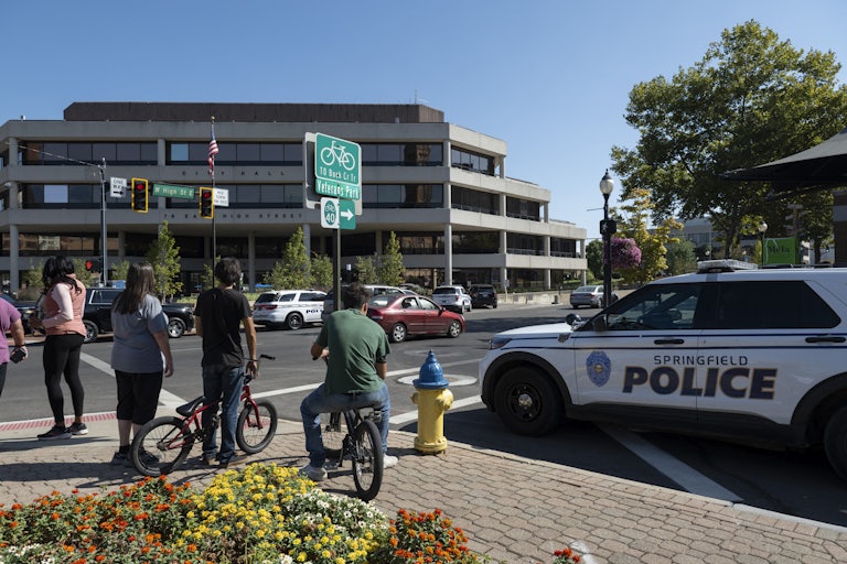 People watch as police investigate City Hall in Springfield, Ohio, after a bomb threat