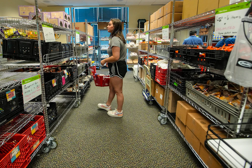 Lexi Emmons, a Junior Nutritional Science major, picks out groceries from the Cougar Cupboard on the first floor of the Campus Recreation and Wellness Center, in the UH Wellness building on the University of Houston campus on Friday, July 22, 2022 in Houston, Texas.