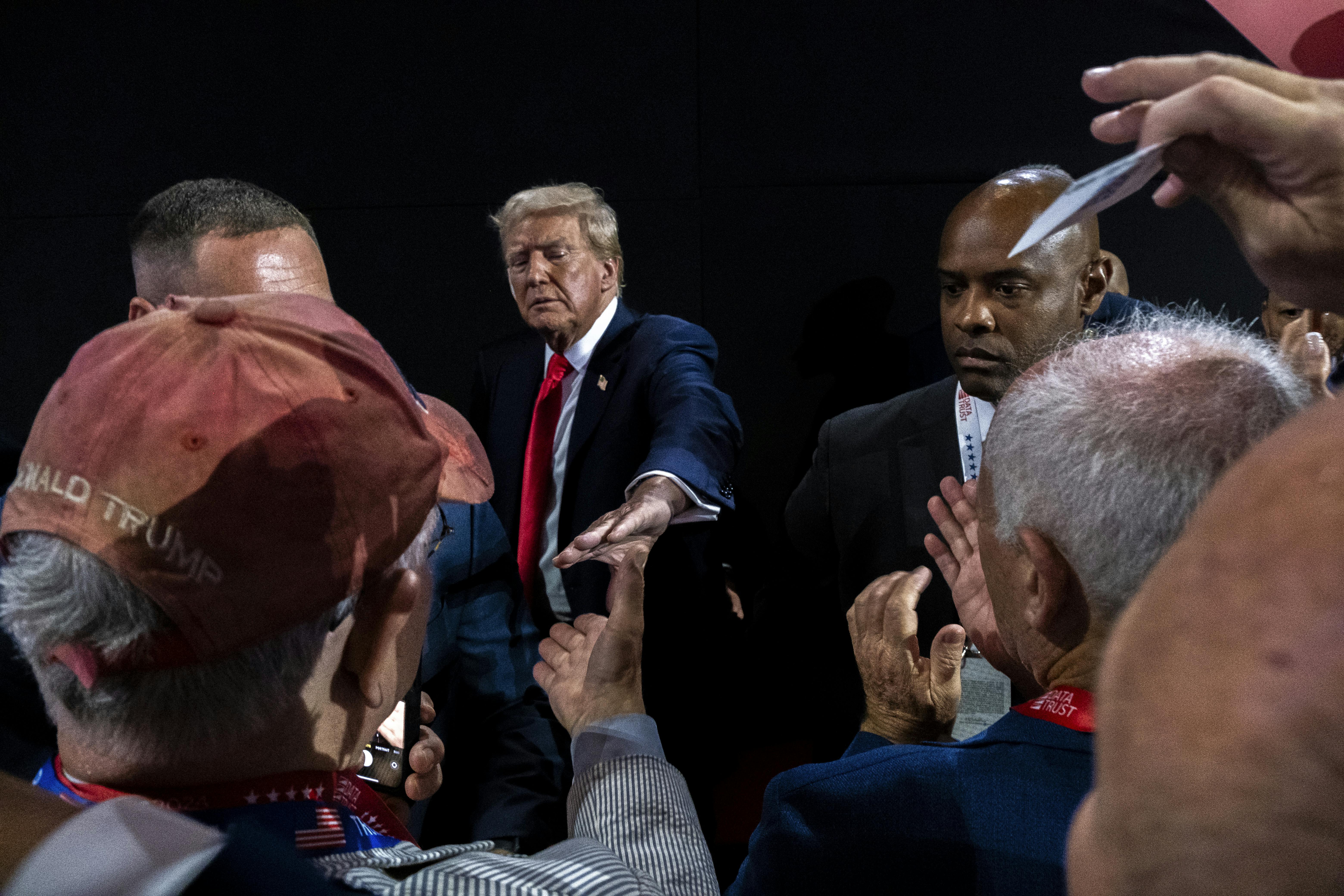 Photograph of Trump reaching out his hand to supporters below him at the Republican National Convention, that is composed like many artistic renderings of Jesus. This convention, Trump has cast himself as a Christ-like savior