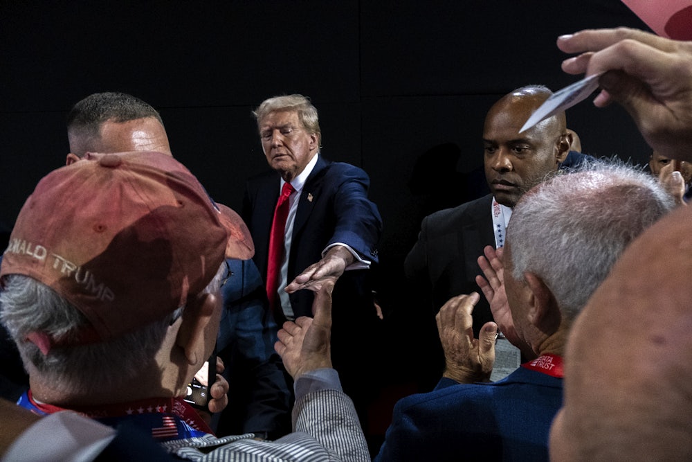 Photograph of Trump reaching out his hand to supporters below him at the Republican National Convention, that is composed like many artistic renderings of Jesus. This convention, Trump has cast himself as a Christ-like savior