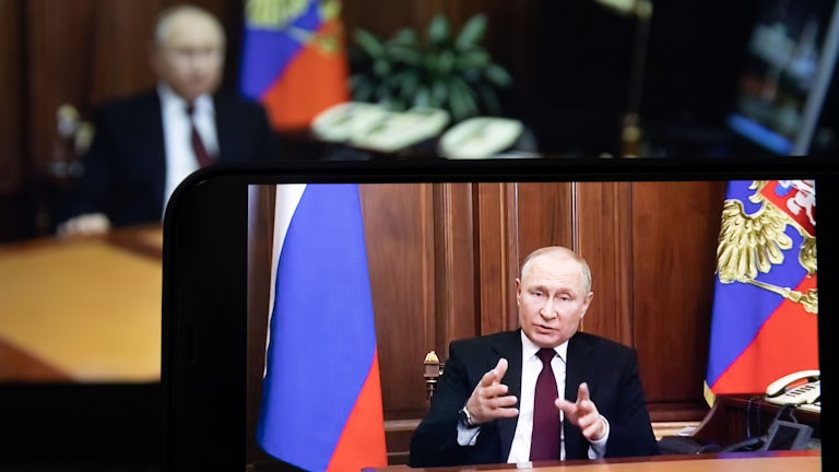 A screen displaying Russian President Vladimir Putin speaking during a televised address to the Russian people.