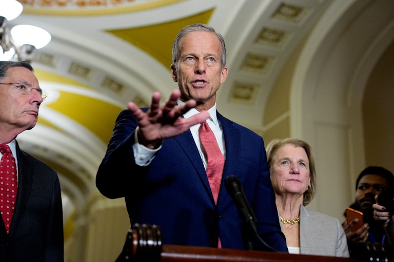 Senate Majority Leader John Thune speaks at a lectern in the Capitol alongside Senate Majority Whip John Barrasso and Senatory Shelley Moore Capito.