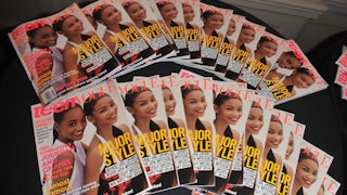 Copies of Teen Vogue magazine are displayed on a table
