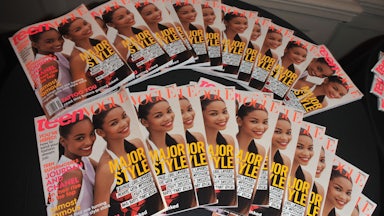 Copies of Teen Vogue magazine are displayed on a table