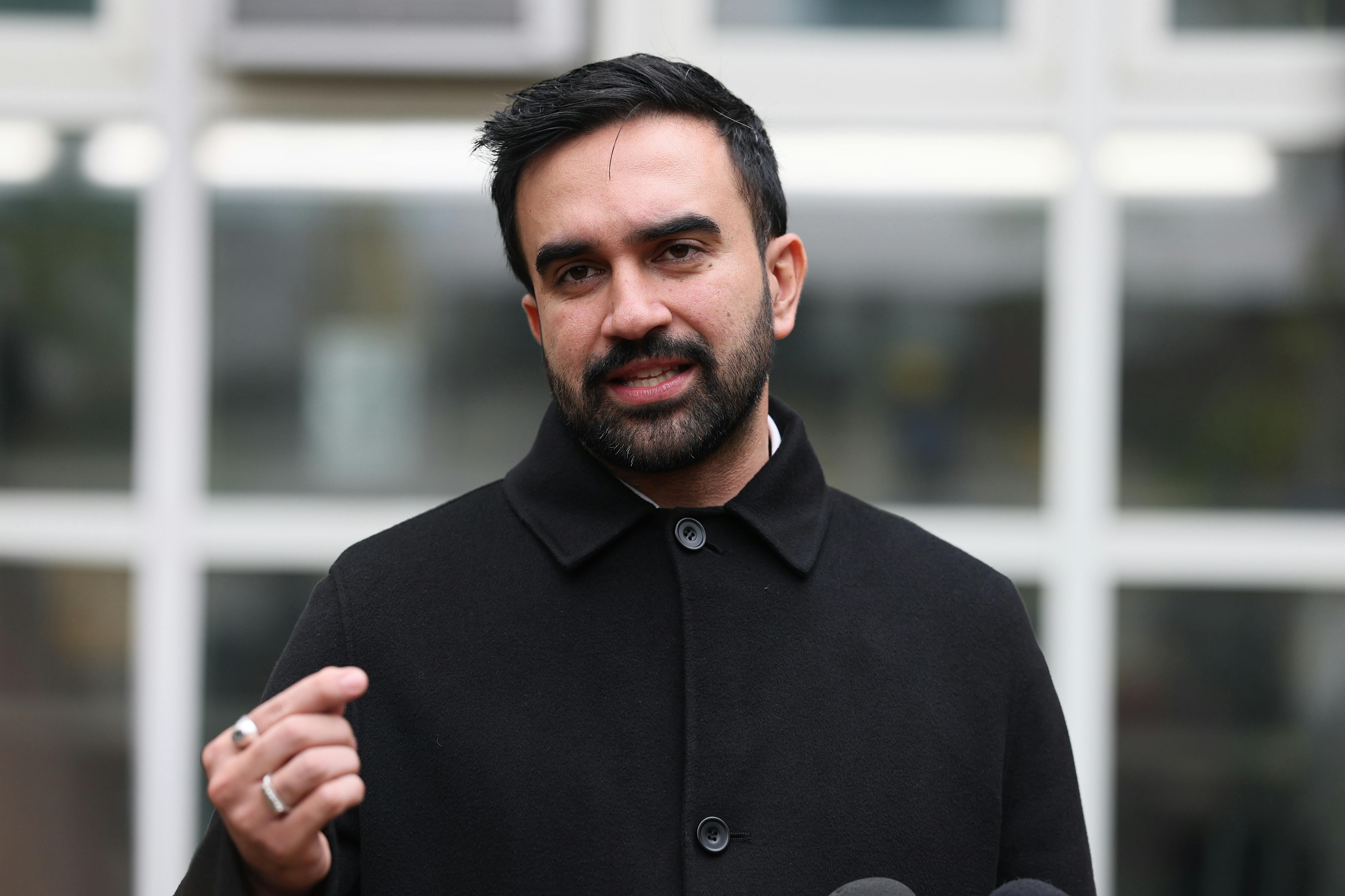 Zohran Mamdani speaks at a lectern.