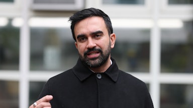 Zohran Mamdani speaks at a lectern.