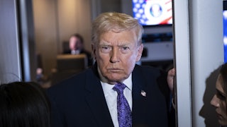 Donald Trump speaks with reporters aboard Air Force One.