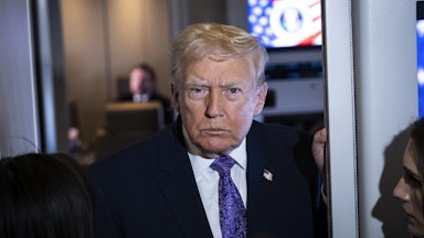 Donald Trump speaks with reporters aboard Air Force One.